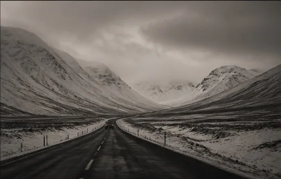 Snow-covered road through mountains
